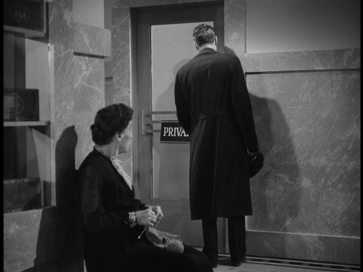 A woman knitting in the foreground watches a man knock on a door marked "Private."