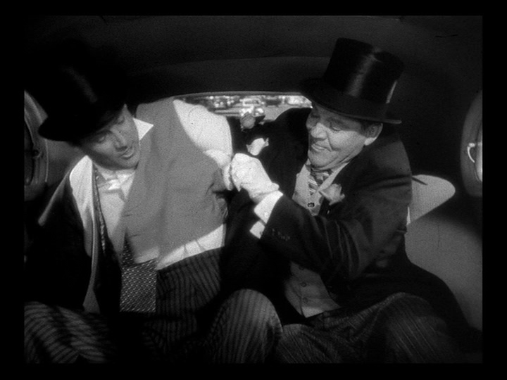 Tom Jeffers struggles to put on a tuxedo in the backseat of a cab with the aid of his best man